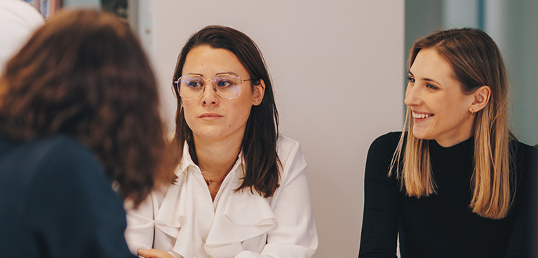 3 women sitting in an office