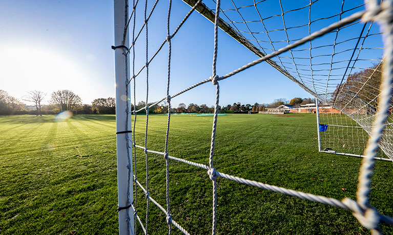 Shot of a football field through the goal net