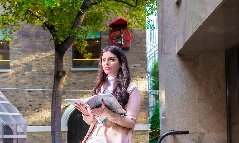 Female student reading a guide book