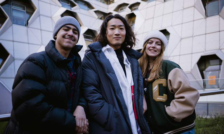 Three students smiling