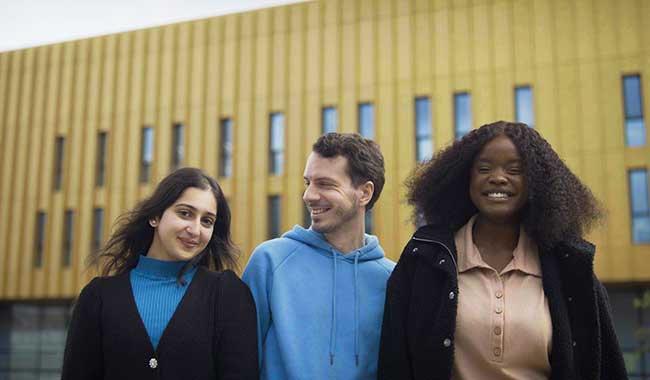 Three students standing outside Delia Derbyshire