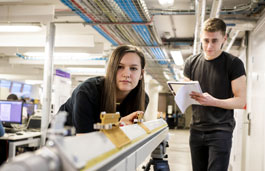 Two students using equipment in the lab.