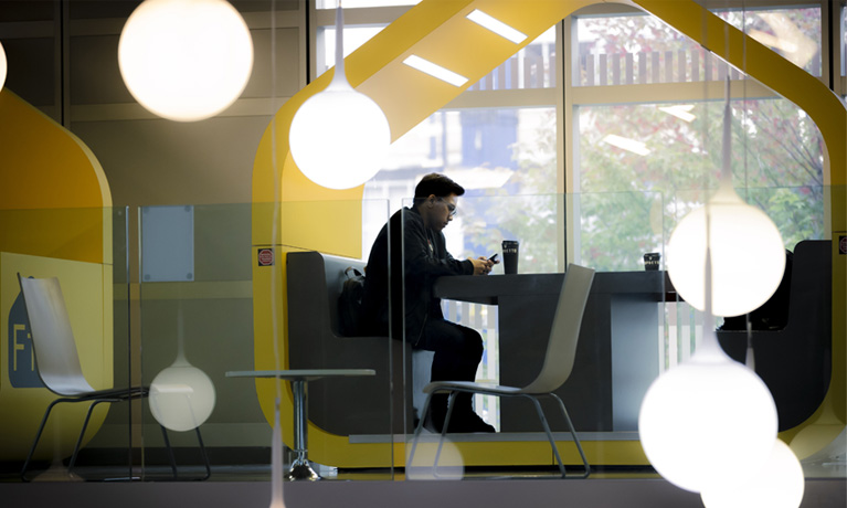 A student working in a booth in The Hub.