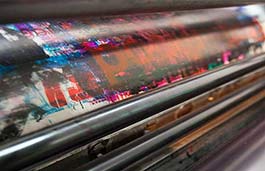 Close up a printing press with paint smudges on a drum 