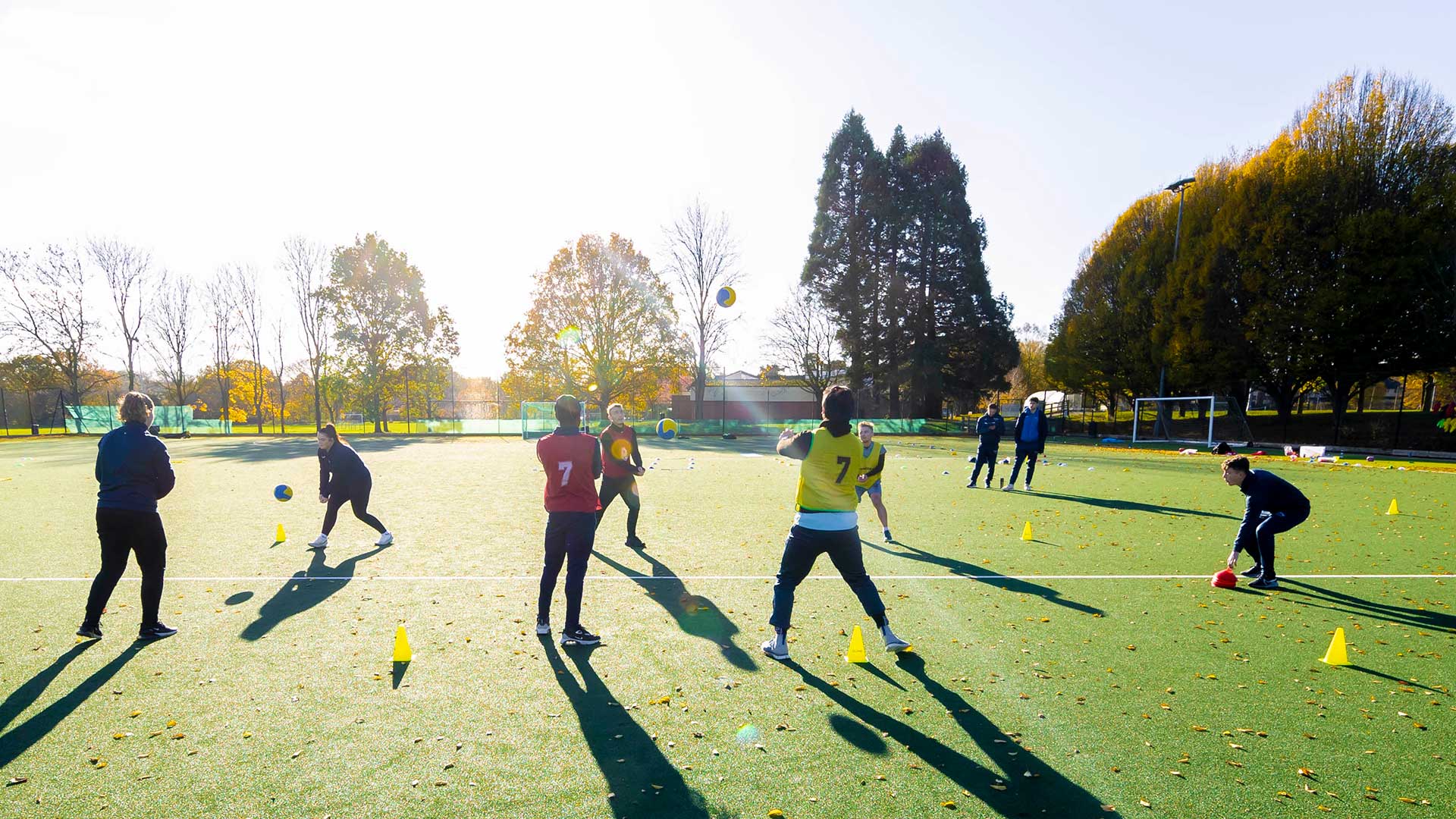 Students on a football pitch training 