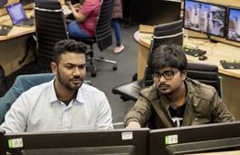 Two students using Bloomberg terminals on the Trading Floor