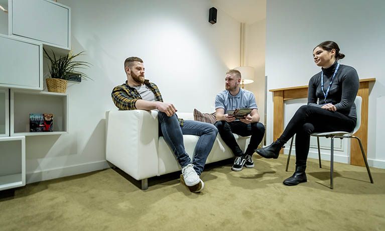 Students practicing patient therapy in a community house setting