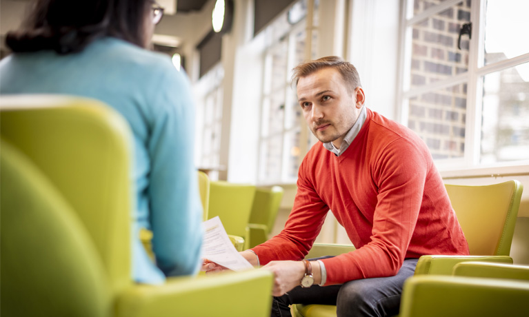 Students talking in a breakout area