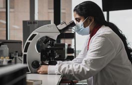 Student looking through a microscope