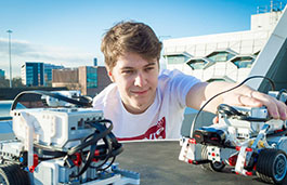 Young student working on a small remote controlled car.