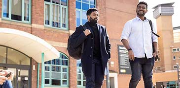 Two male students walking on campus