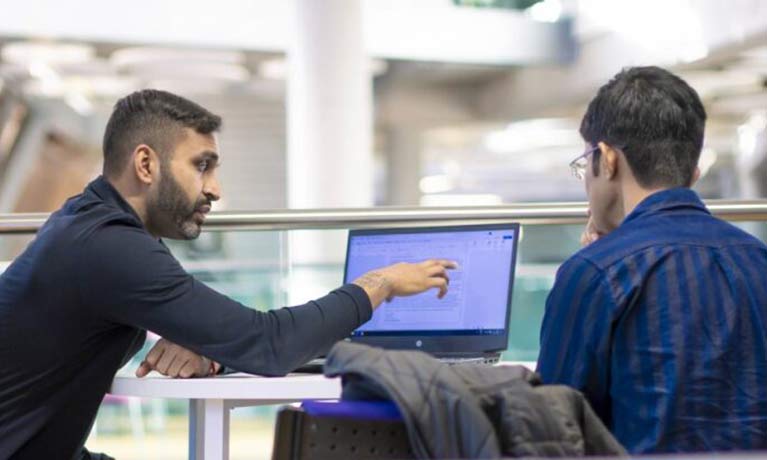 Career support officer helping a male student