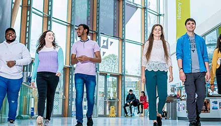 Group of young students walking through the Herbert Gallery 