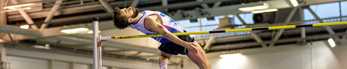 high jumper in flight over the high pole