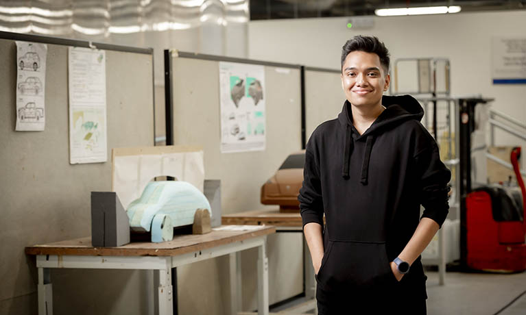 Apprentice smiling standing in a design studio