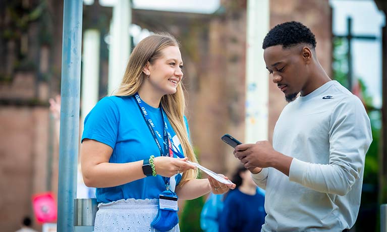 Student talking to a students union rep in cathedral square