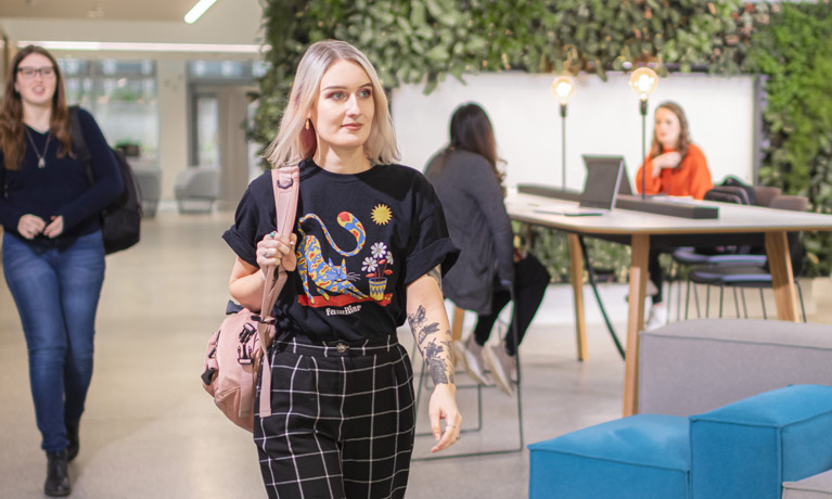 Female student walking in the hub 