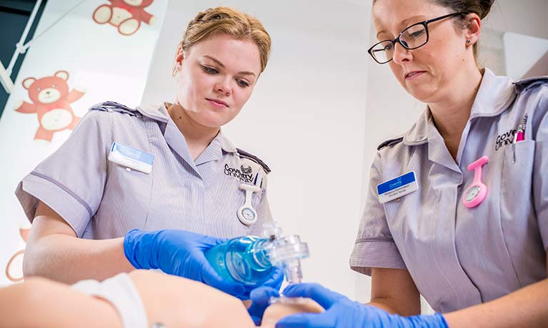 student nurse Katie Hughes working on a model baby