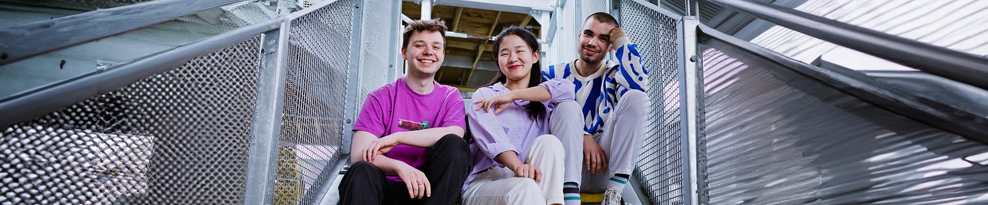 Two students sat on a staircase outside