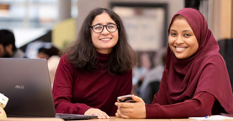 Students smiling looking at the camera