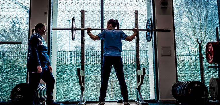 two women training in a gym