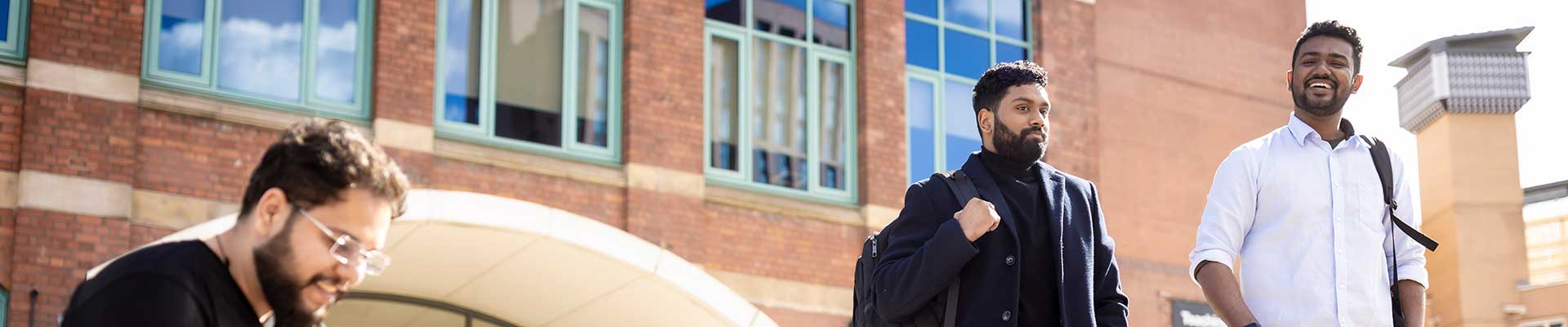 Two students walking away from the William Morris building