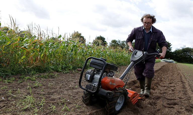 Man in the field with a lawn mower