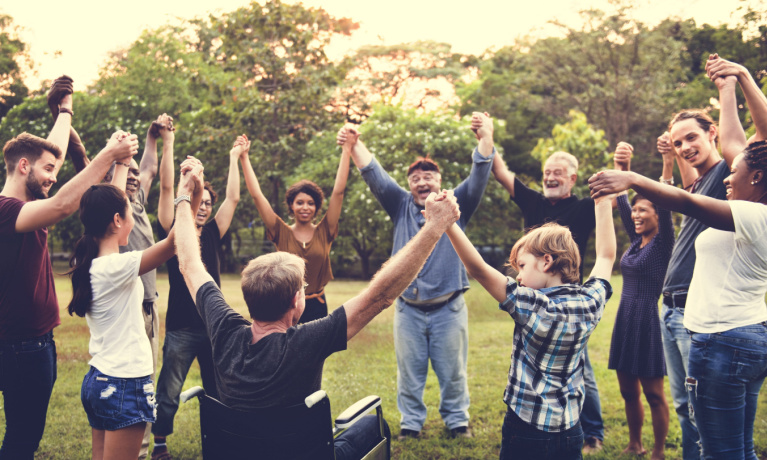 Group of people celebrating with their hands up