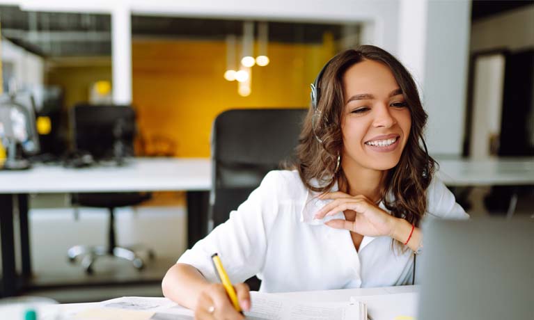 Woman smiling at computer whilst on virtual call