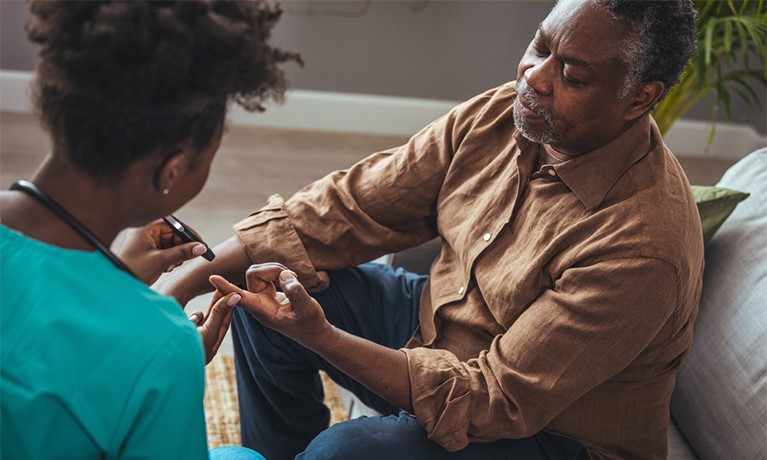 Man having his blood sugar levels checked by healthcare professional