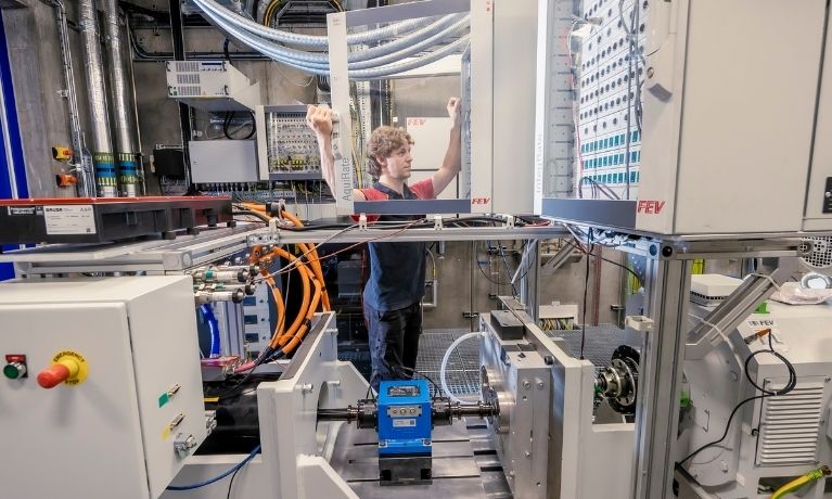 person opening transparent cabinet in a lab setting