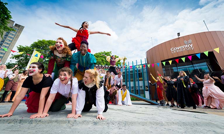 Group of drama students  performing on campus