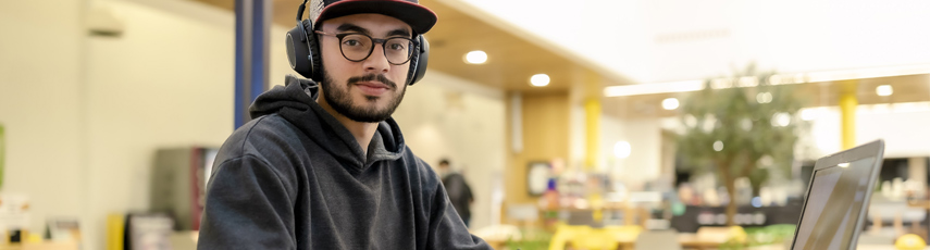 Student using a laptop in The Hub cafe