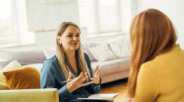 2 women in discussion in smart dress