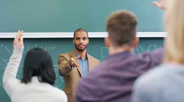 Teacher standing in front of a classroom of pupils