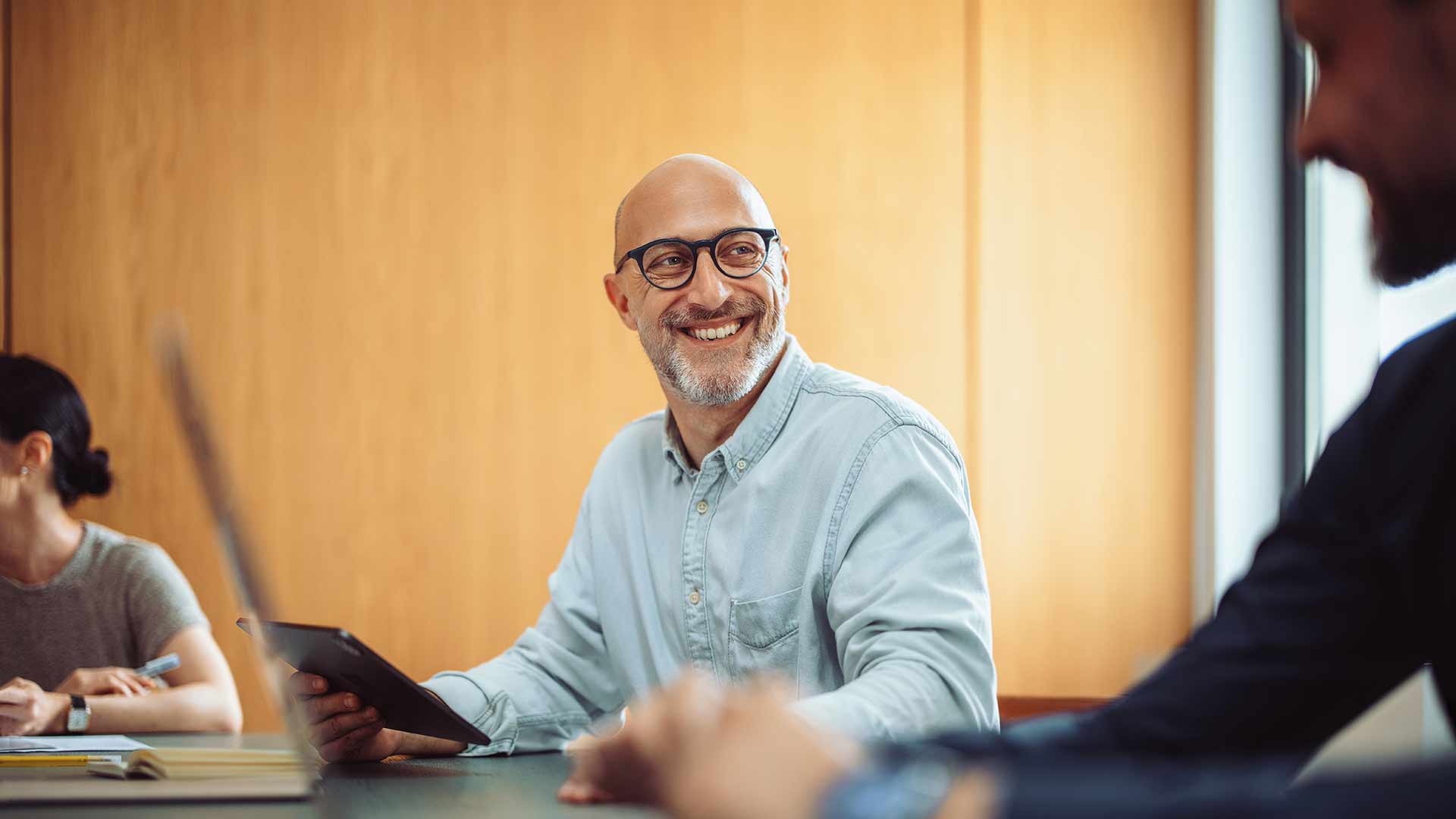 A man in a shirt in a meeting room in an office 