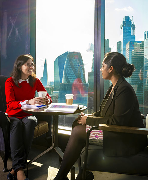 women having a conversation in a social setting