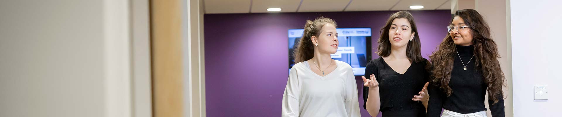 3 students walking in a corridor