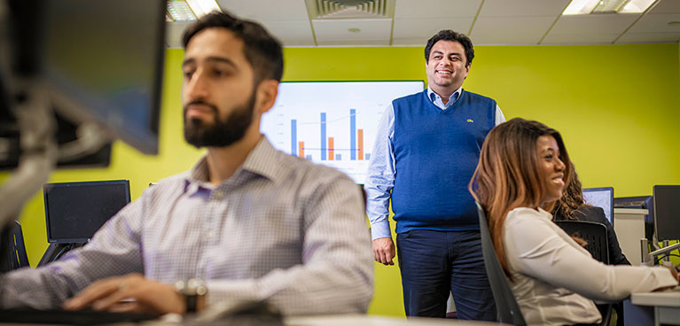 tutor looking over his students in a seminar room