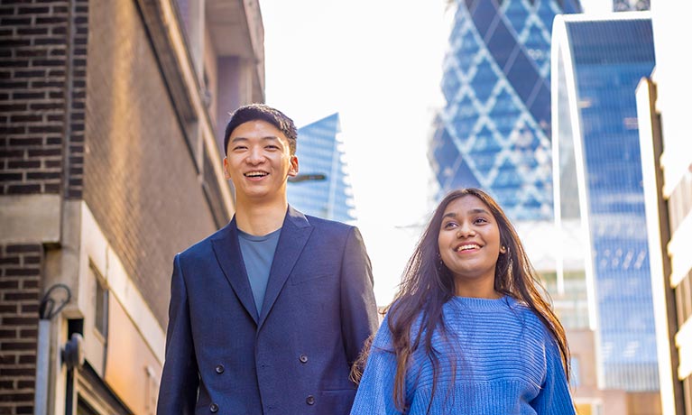 Male and female walking on a street in London