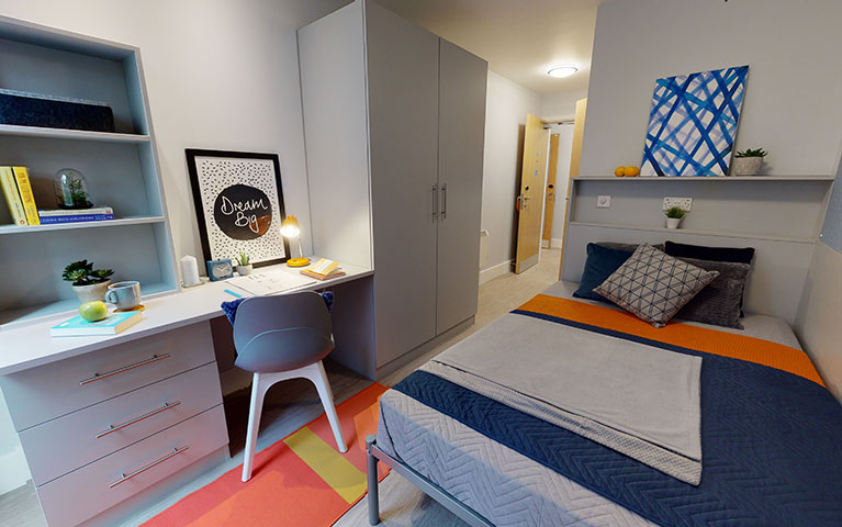 Bed with desk and chair in Magenta House accommodation