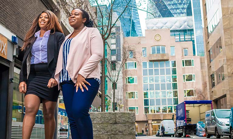 two female students walking outside of a London campus