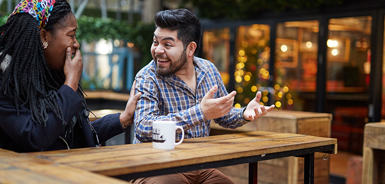 Man and woman talking together in a coffee shop