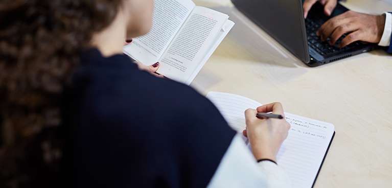 Woman writing in a note pad