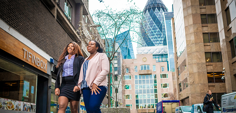 two women walking together on a London street