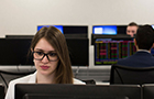 Female sitting in a classroom looking at a screen