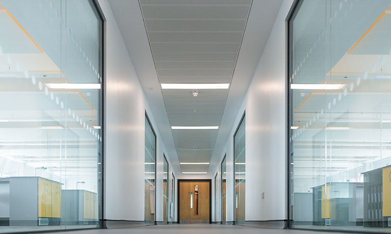 Long corridor with glass doors either side