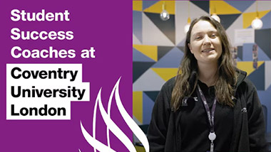 Woman smiling for a photo in a university seminar room