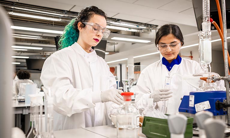 Two young students working in a medical lab