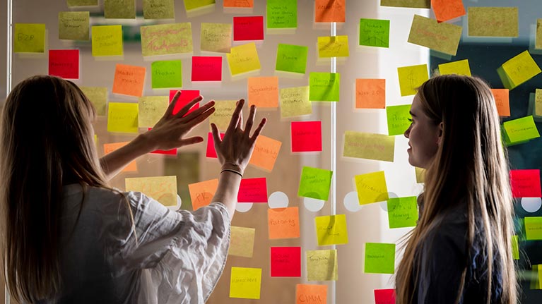 students arranging colourful post it notes 